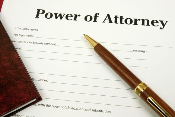 power of attorney typed on paper with a pen laying across it
