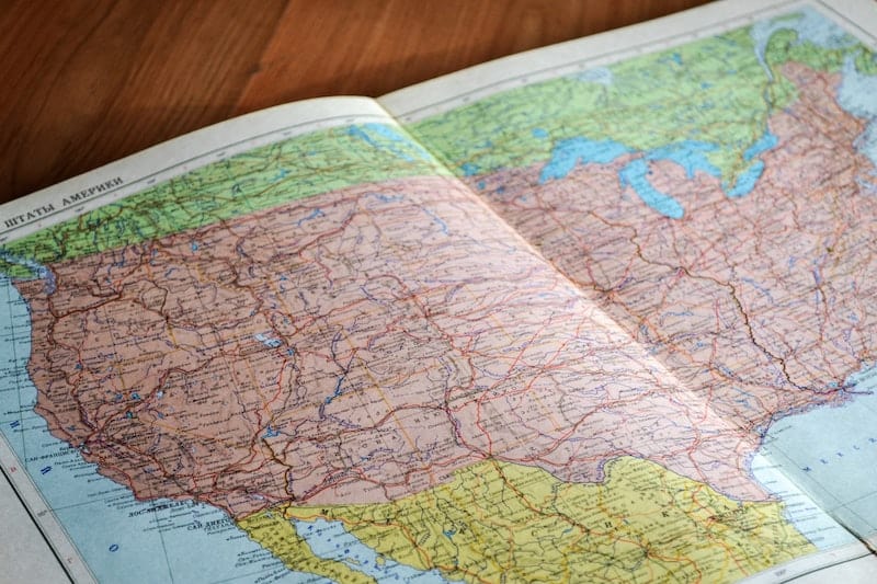 map of the united states laid on a wooden table. might be used to plan moving out of the U.S.